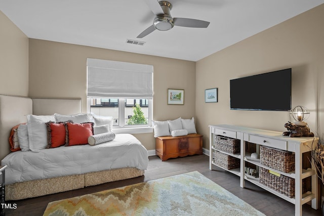 bedroom featuring visible vents, ceiling fan, baseboards, and wood finished floors