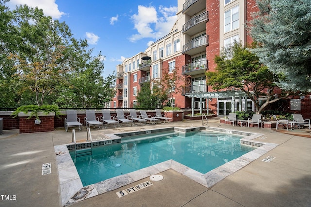 view of swimming pool featuring a patio area