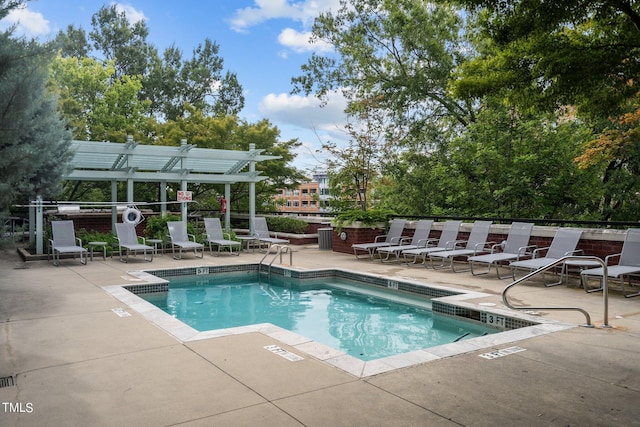 pool with a patio area and a pergola