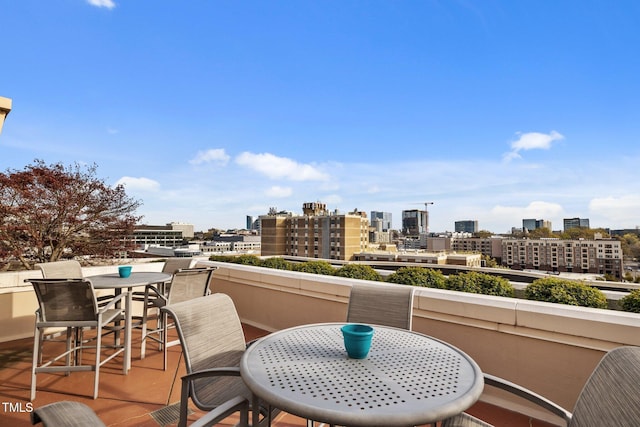 balcony with a city view and outdoor dining space