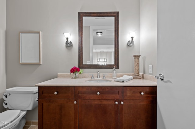 bathroom featuring vanity and toilet