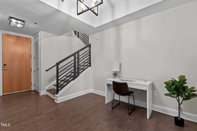 office space featuring baseboards, a notable chandelier, and wood finished floors