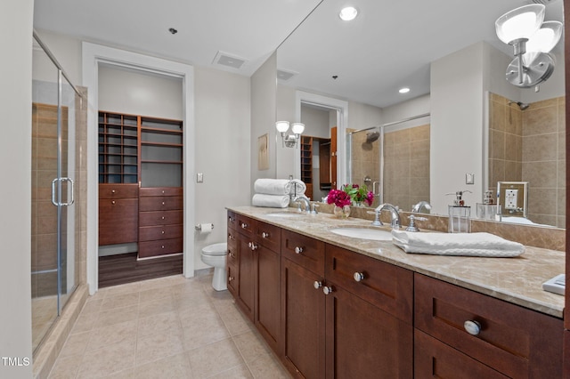 full bathroom featuring a shower stall, tile patterned floors, and a sink