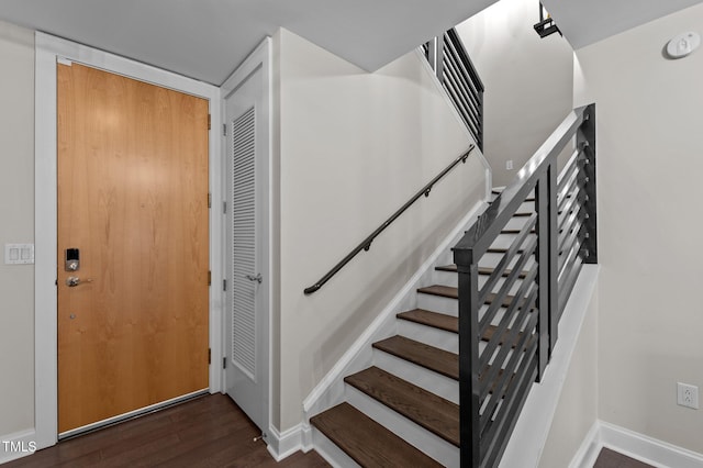 stairs featuring baseboards and wood finished floors