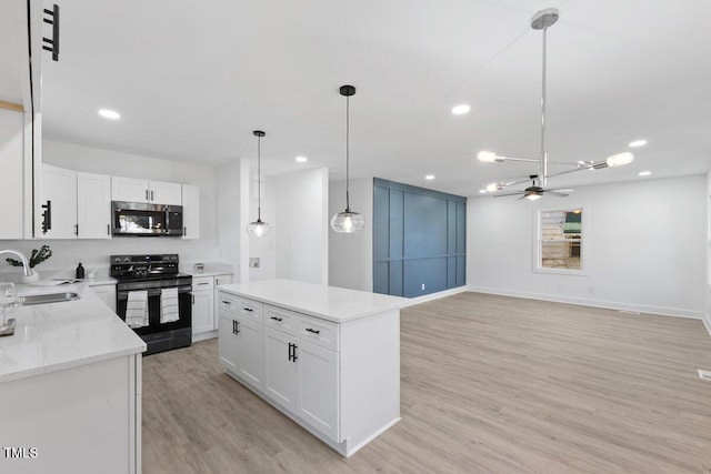 kitchen with white cabinetry, black range with electric cooktop, decorative light fixtures, and a kitchen island