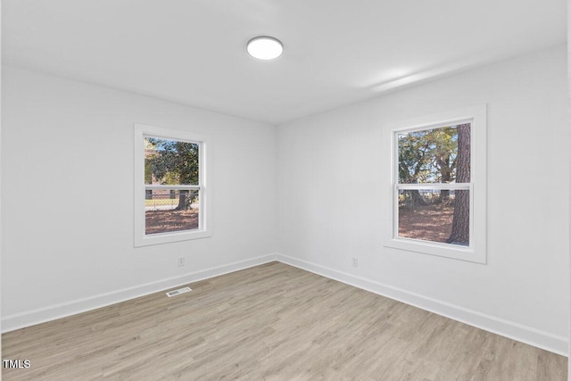 spare room with light wood-type flooring