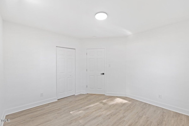 unfurnished room with light wood-type flooring