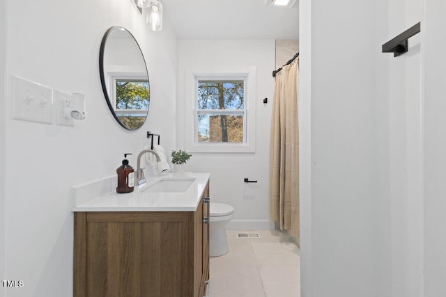 bathroom featuring vanity, tile patterned flooring, and toilet