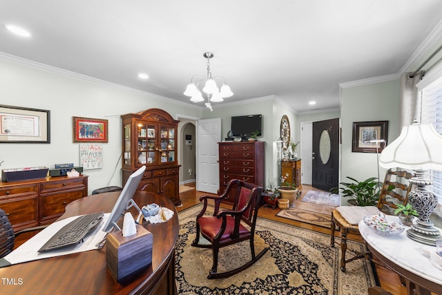 office area with an inviting chandelier, ornamental molding, and light wood-type flooring