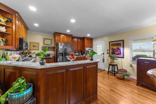 kitchen with light stone counters, kitchen peninsula, stainless steel appliances, crown molding, and light wood-type flooring