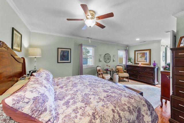 bedroom featuring ceiling fan, ornamental molding, and light hardwood / wood-style flooring