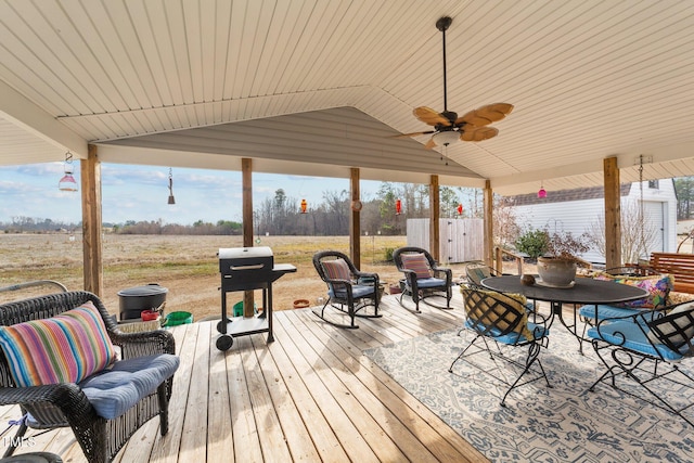 wooden terrace featuring ceiling fan and a grill