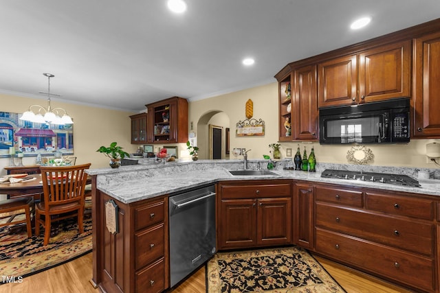 kitchen with crown molding, stainless steel appliances, light stone countertops, and sink