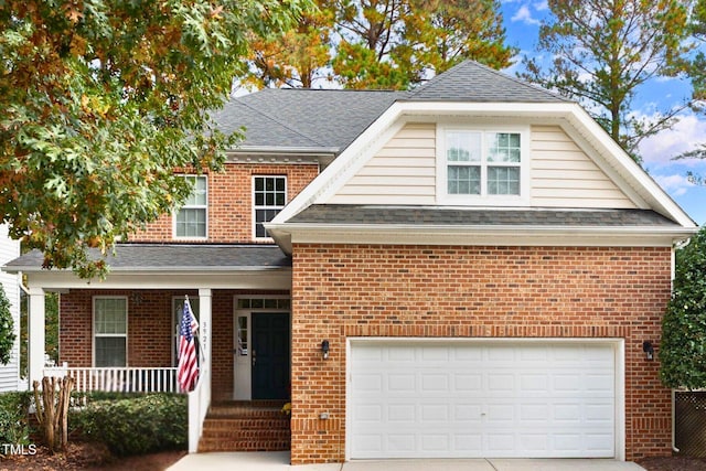 view of front of property featuring a garage and covered porch