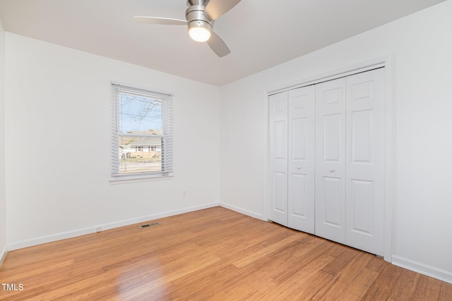 unfurnished bedroom with ceiling fan, light hardwood / wood-style floors, and a closet