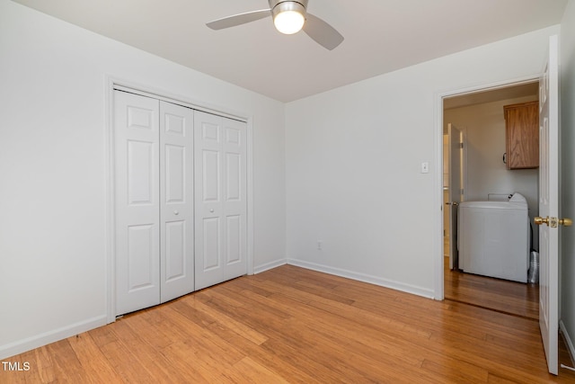 unfurnished bedroom featuring washer / clothes dryer, a closet, ceiling fan, and light hardwood / wood-style flooring