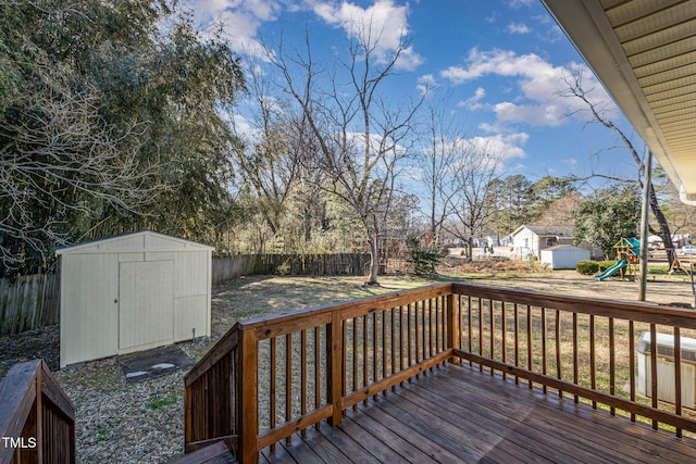 wooden deck featuring a storage unit and a playground