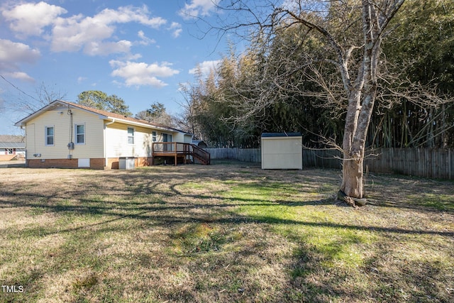 view of yard with a wooden deck and a shed