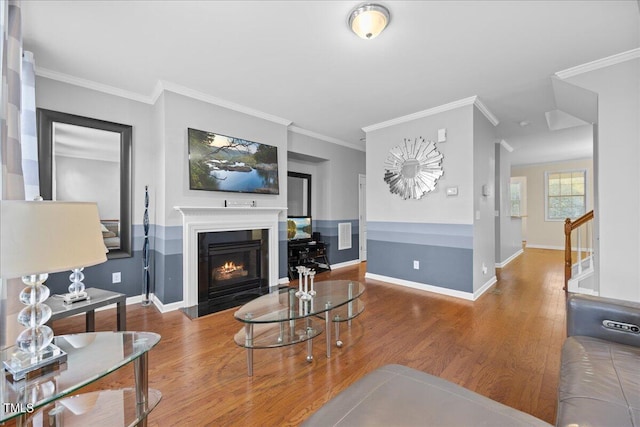 living room with hardwood / wood-style flooring and crown molding