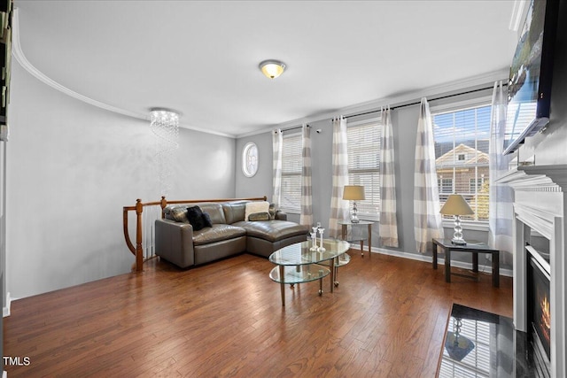 living room with dark hardwood / wood-style flooring and crown molding