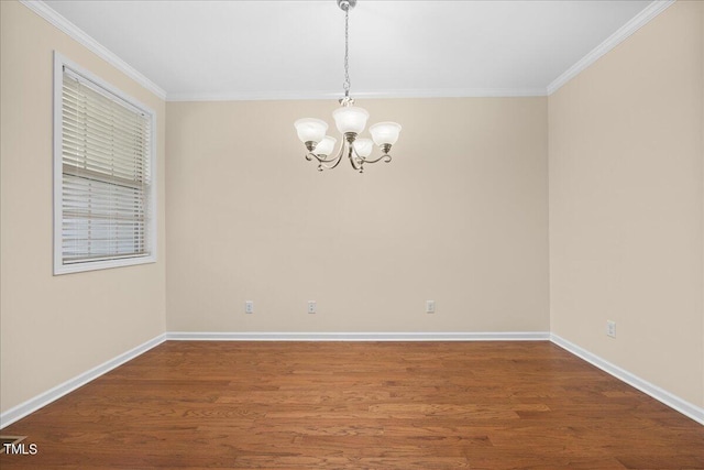 empty room featuring crown molding, hardwood / wood-style floors, and an inviting chandelier