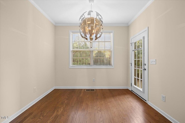 unfurnished dining area featuring ornamental molding, a chandelier, and hardwood / wood-style floors