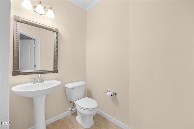 bathroom featuring crown molding, sink, tile patterned floors, and toilet