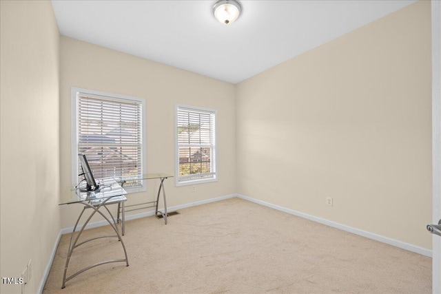 sitting room featuring light carpet