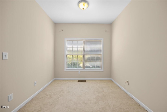 unfurnished room with light carpet