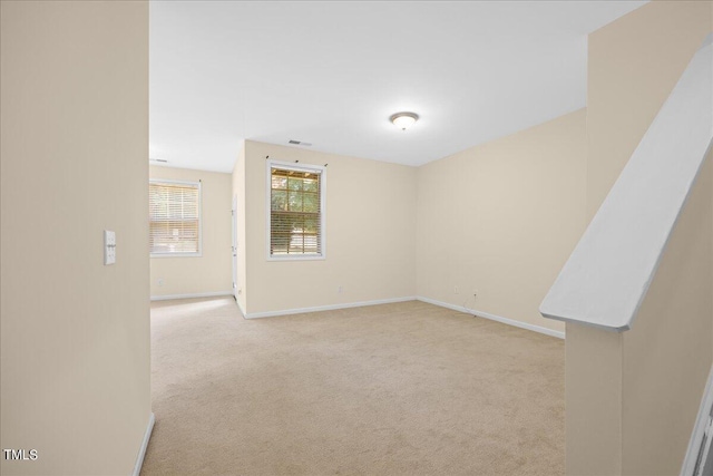 unfurnished room with light carpet