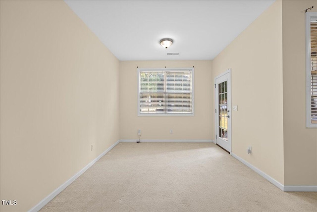 spare room with light colored carpet