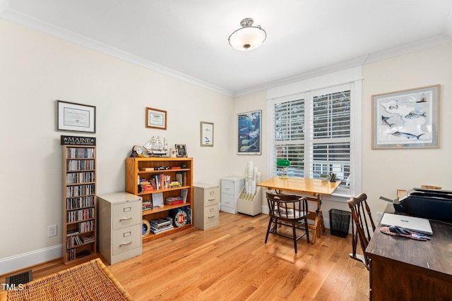 home office with crown molding and light hardwood / wood-style floors