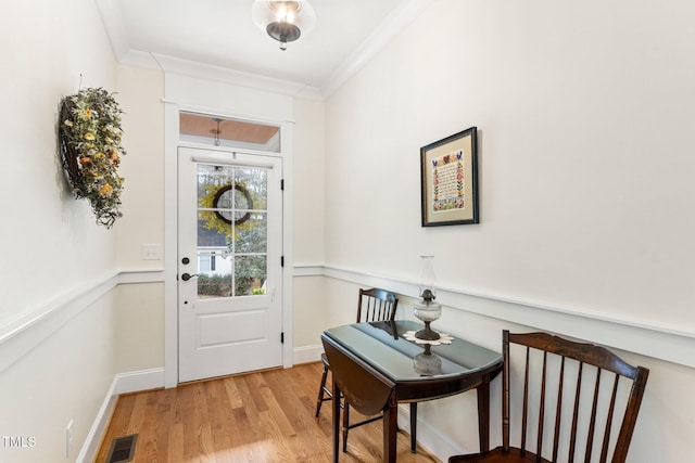 entryway featuring hardwood / wood-style flooring and crown molding