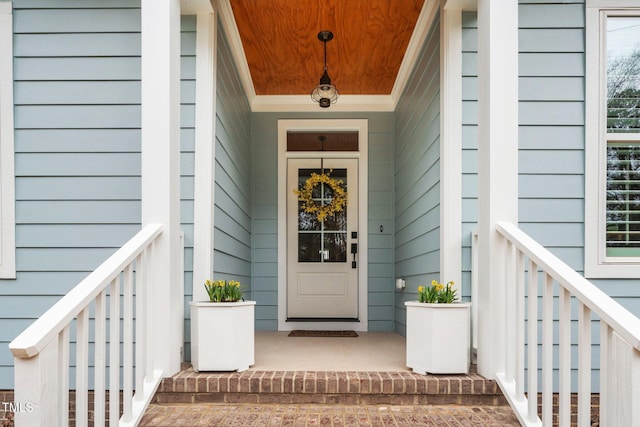 view of exterior entry with a porch