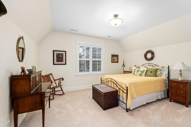 bedroom featuring lofted ceiling and light colored carpet