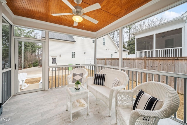 sunroom / solarium with wood ceiling and ceiling fan