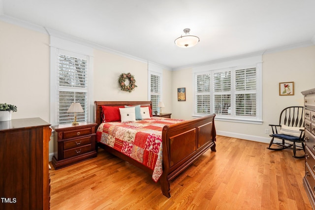 bedroom with crown molding and light hardwood / wood-style floors