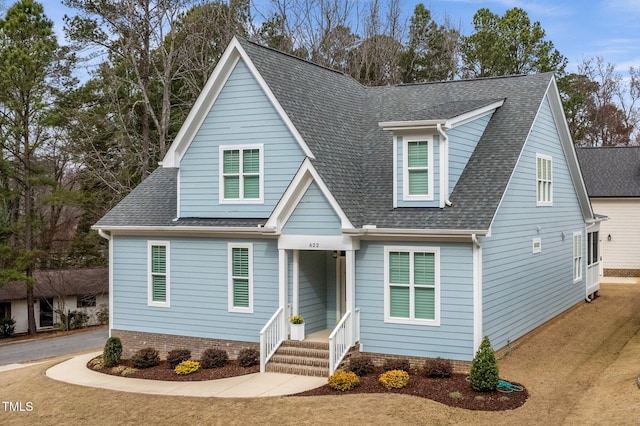 view of front facade with roof with shingles