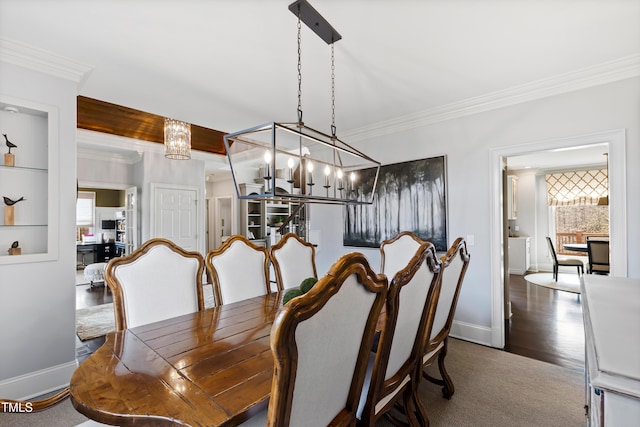 dining room featuring ornamental molding, a chandelier, a healthy amount of sunlight, and baseboards