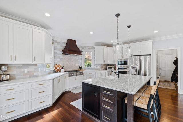 kitchen with a breakfast bar, white cabinetry, custom exhaust hood, and stainless steel appliances