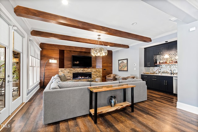 living area with dark wood-type flooring, wet bar, beam ceiling, and a fireplace