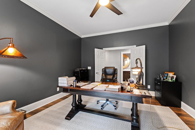 home office featuring crown molding, ceiling fan, wood finished floors, and baseboards