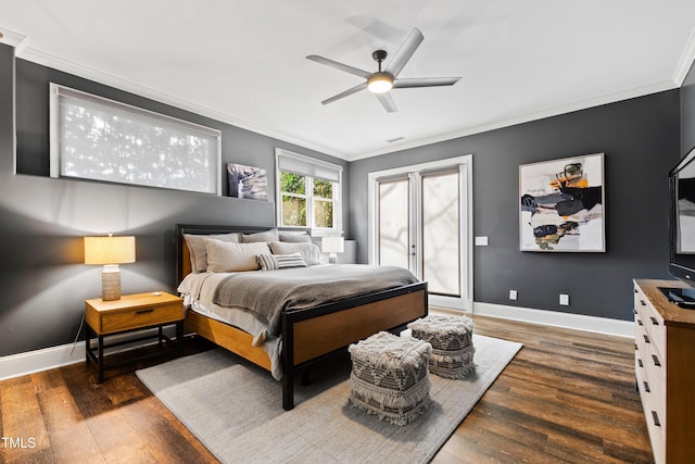 bedroom featuring baseboards, ornamental molding, and wood finished floors