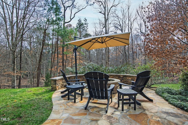 view of patio with fence and a wooded view