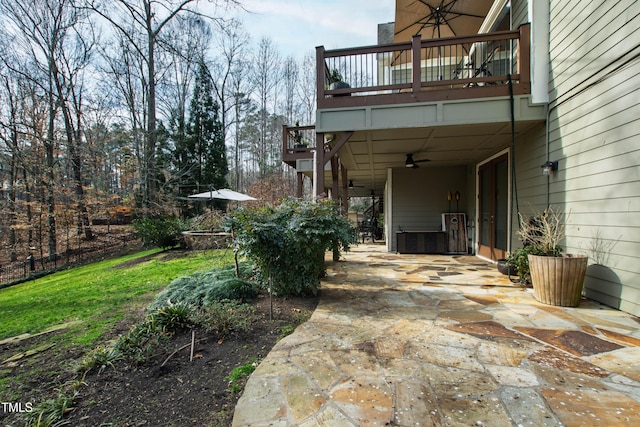 exterior space with ceiling fan and a balcony