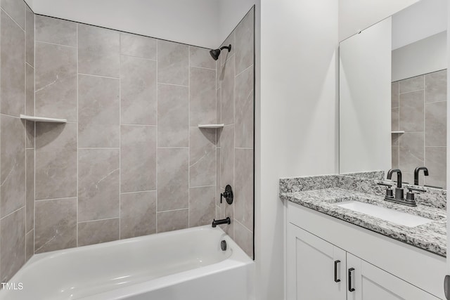 bathroom with vanity and tiled shower / bath combo