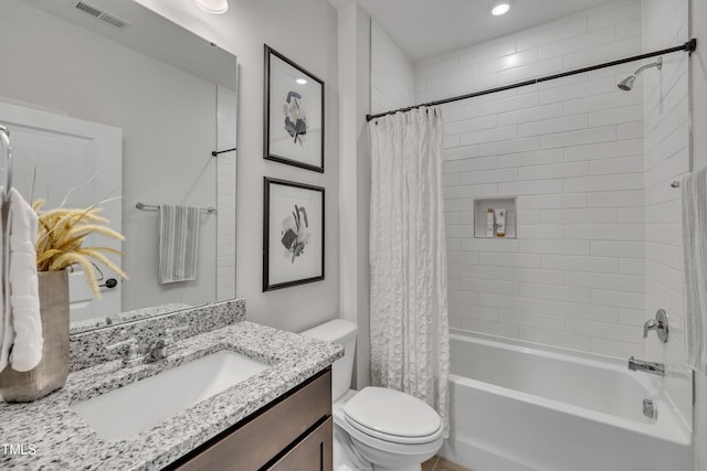 full bathroom with vanity, shower / bath combo, and toilet