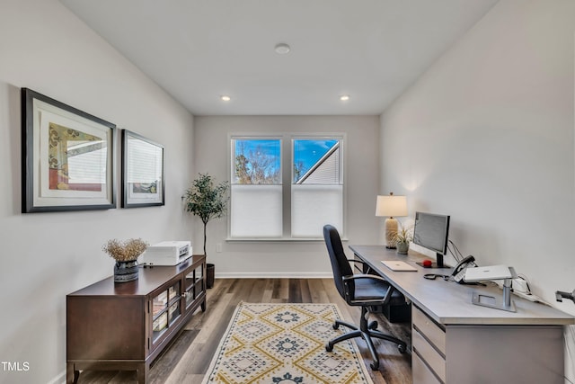 home office with dark hardwood / wood-style flooring