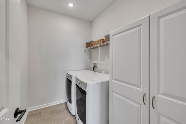 laundry room featuring light tile patterned floors and washing machine and dryer