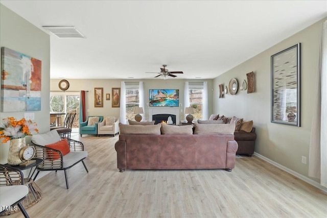 living room featuring ceiling fan and light wood-type flooring